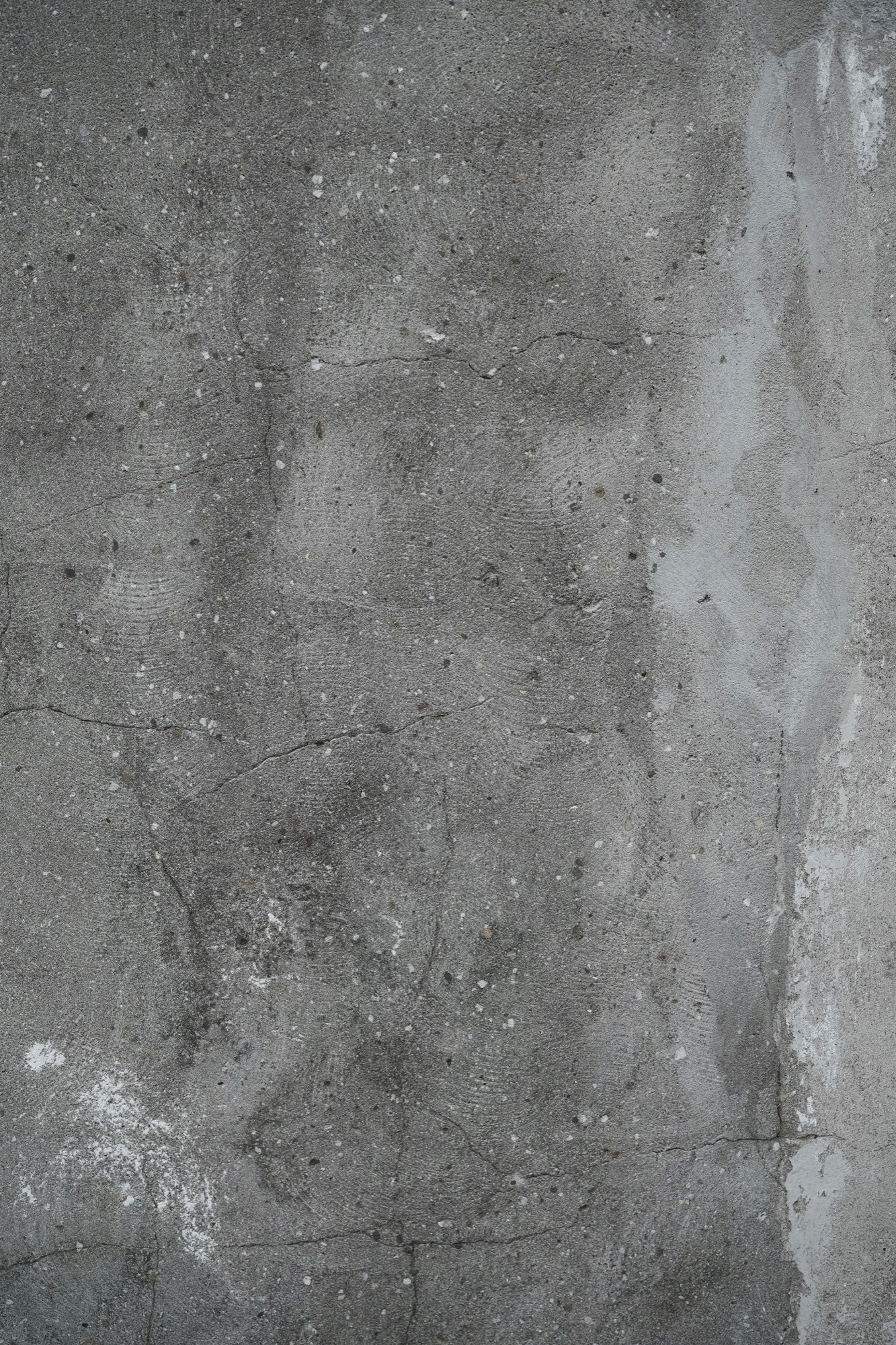 Close-up of a cracked, water-stained concrete wall